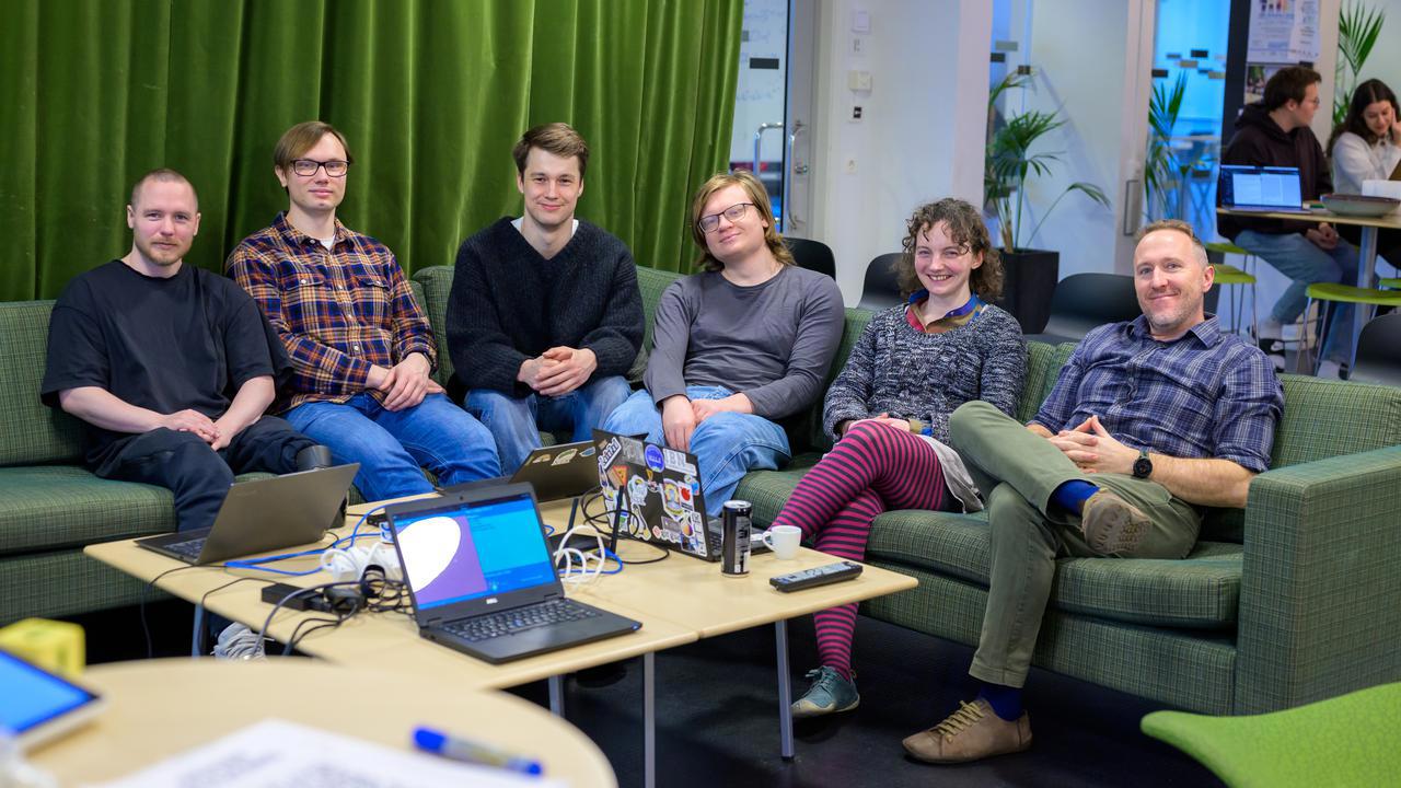 A group of people sitting on couches in a room.