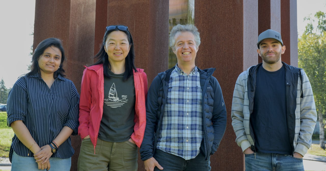 A group of people standing next to each other outside.