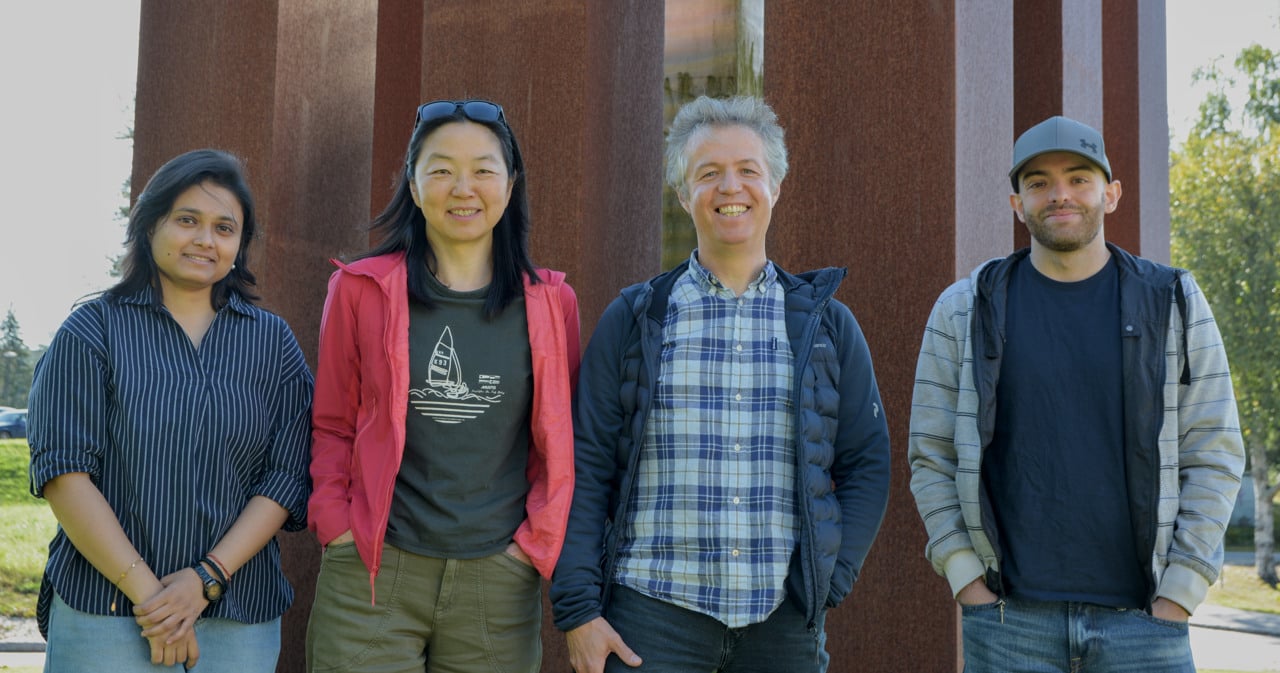 A group of people standing next to each other outside.