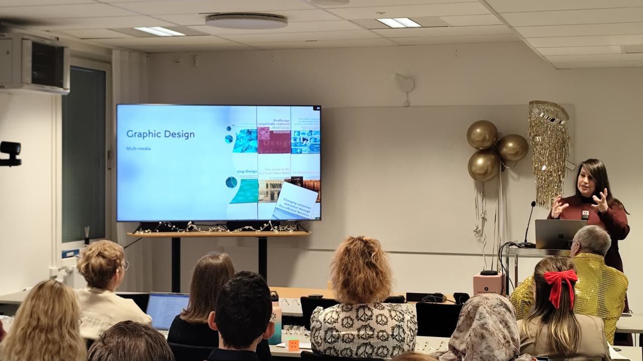 A woman giving a presentation to a group of people.
