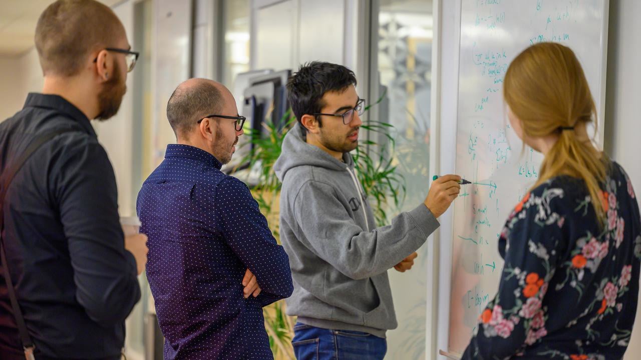 IceLab members working together on a whiteboard