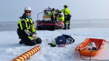 A woman working with sampling on ice in the Arctic.