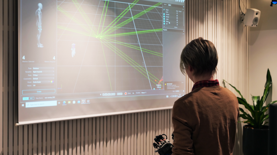Screen displaying movements from person wearing Motion Capture equipment.