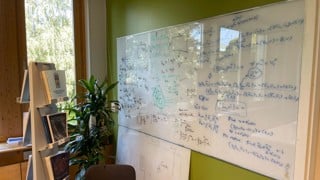 En stor whiteboard med text på.