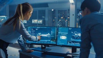 Female and Male Engineers are Discussing the 3D CAD Software Render of an Electric Concet Car. High Tech Laboratory with a Prototype Vehicle Chassis.