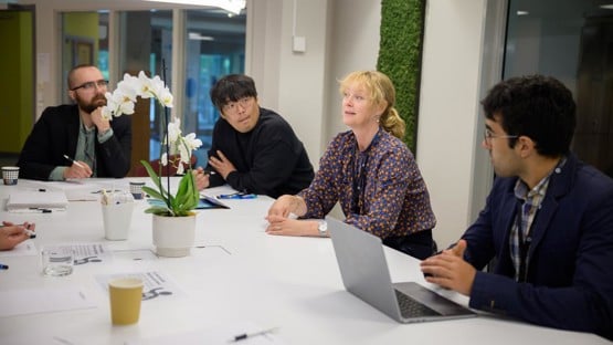 Professor Åsa Strand discusses a new project idea in plant stress response modeling with other researchers, including Seong-Gyu Yang, IceLab and Department of Physics postdoctoral fellow.