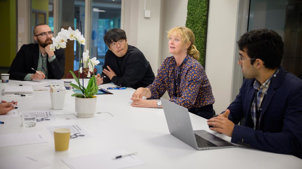 Professor Åsa Strand discusses a new project idea in plant stress response modeling with other researchers, including Seong-Gyu Yang, IceLab and Department of Physics postdoctoral fellow.