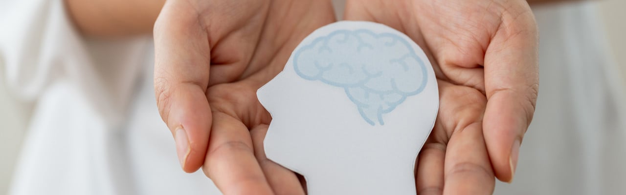 Mental health awareness, human hand care and support hold white paper head and glowing brain with physical and mental health, wellbeing, brain health, psychological support, healthcare and mindfulness