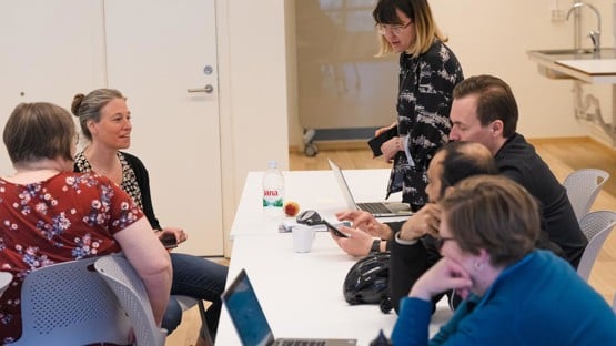 Students around table discussing