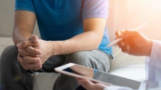 Men's health disease, on prostate cancer or mental illness concept with male patient having consultation with doctor or psychiatrist working on diagnostic examination in medical clinic or hospital