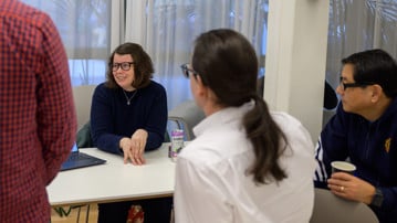 Sophia Harlid discusses her pitch with attendees