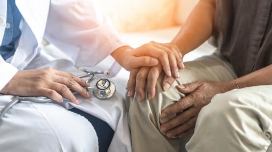 Parkinson's disease patient, Arthritis hand and knee pain or mental health care concept with geriatric doctor consulting examining elderly senior aged adult in medical exam clinic or hospital