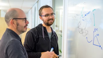 Ludvig Lizana and Lucas Hedström explore gene regulation dynamics on a whiteboard in IceLab