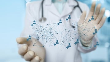 Doctor shows a medical network on a blurred background.