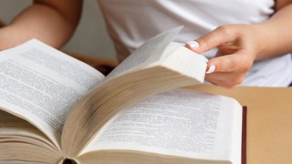 Close up on hands reading a book