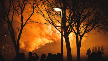 Intense flames from a massive forest fire. Flames light up the night as they rage thru pine forests and sage brush.