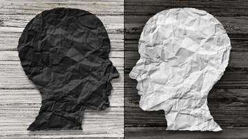 Bipolar mental health and brain disorder concept as a human head in paper divided in two colors as a neurological mood and emotion symbol or medical psychological metaphor for social behavior challenges in a 3D illustration style.