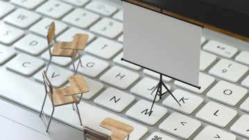 projection screen and chairs on the keyboard of a latop, 3d rendering,conceptual image. training and e-learning concepts.