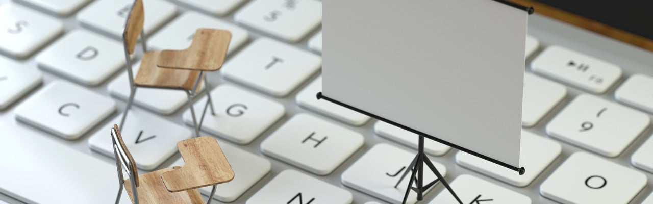 projection screen and chairs on the keyboard of a latop, 3d rendering,conceptual image. training and e-learning concepts.