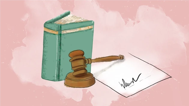 A law book, a wooden mallet and a signed agreement.