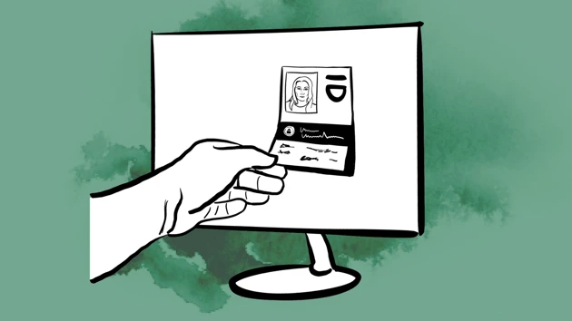 Hand plockar ut en identifikation från en dator. 