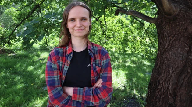 Photo of Katharina Schmid, trees in the background