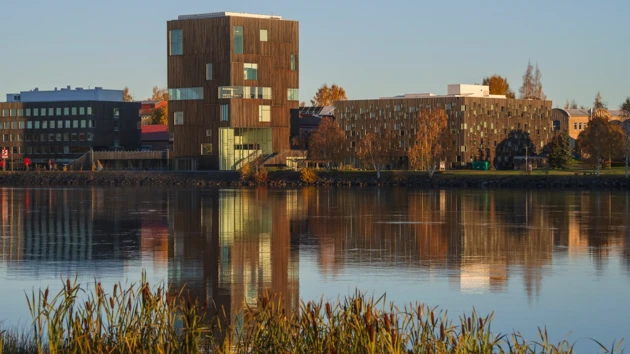 buildings at art campus seen from across Umeålven