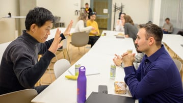 Jian-Feng Mao and Cemal Erdem discuss Cemal's lunch pitch