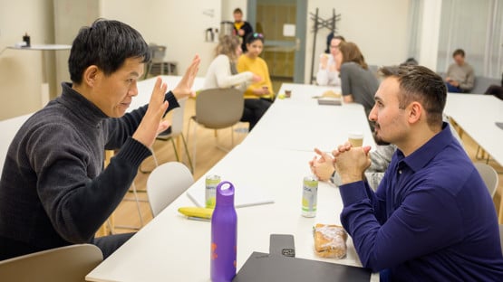 Jian-Feng Mao and Cemal Erdem discuss Cemal's lunch pitch