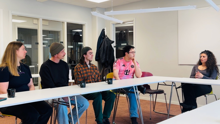 Students along a table discussing