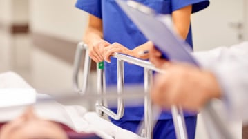 Detalj från en akutvårdsavdelning. Vårdpersonal med en patient på bår.