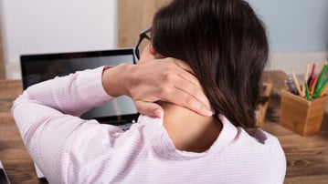 Businesswoman Having Pain In Neck