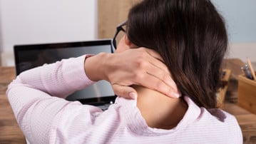 Businesswoman Having Pain In Neck