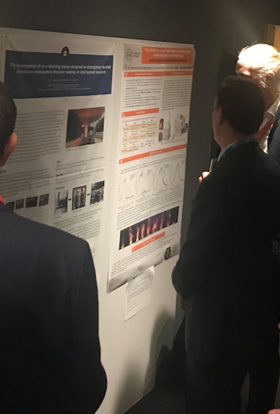 People looking at a poster