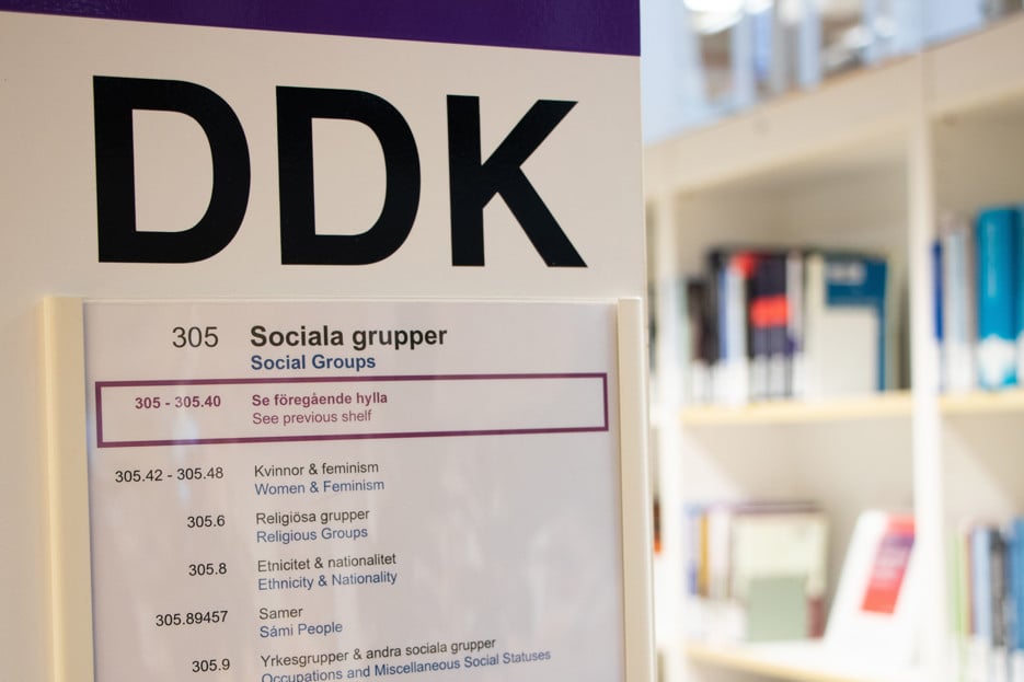 The image shows signage on a shelf.