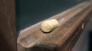 Detaljbild på en äldre griffeltavla i en skolmiljö